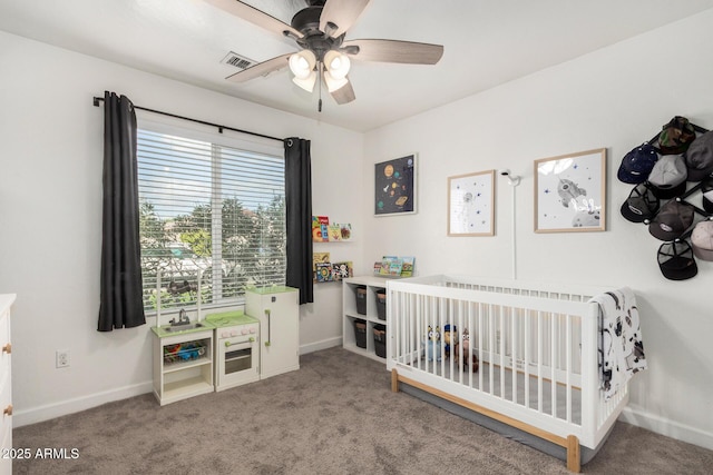 bedroom featuring a nursery area, baseboards, visible vents, and carpet flooring