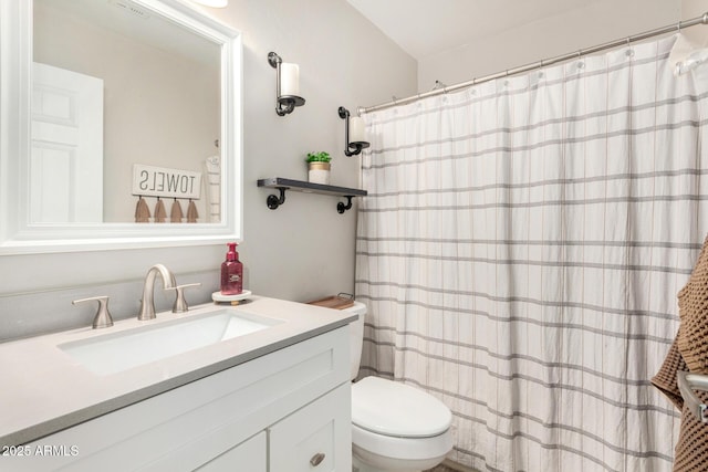 bathroom with a shower with shower curtain, vanity, and toilet