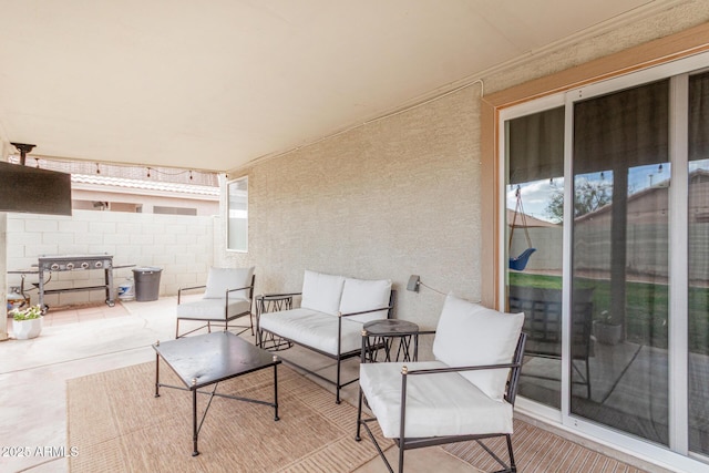 view of patio / terrace featuring fence and an outdoor hangout area