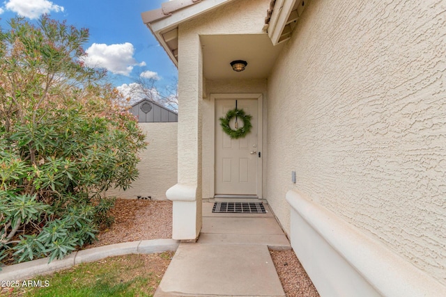 property entrance with stucco siding