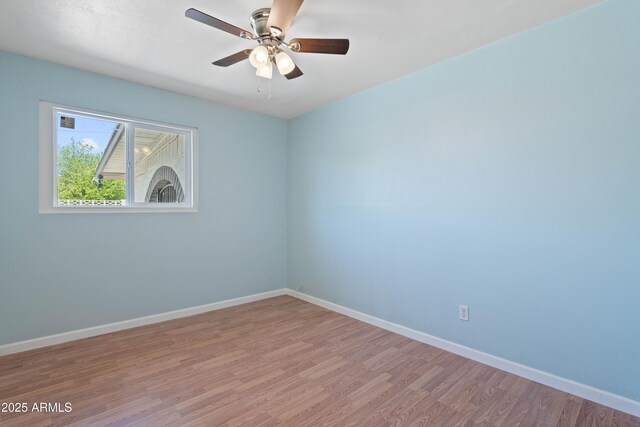 5802 N 61st Dr, Glendale, AZ 85301 - empty room featuring light wood finished floors, baseboards, and ceiling fan