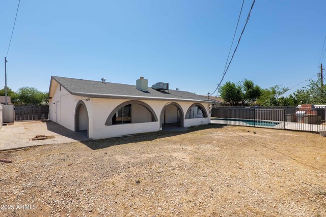 5802 N 61st Dr, Glendale, AZ 85301 - back of house with a chimney, brick siding, and a patio