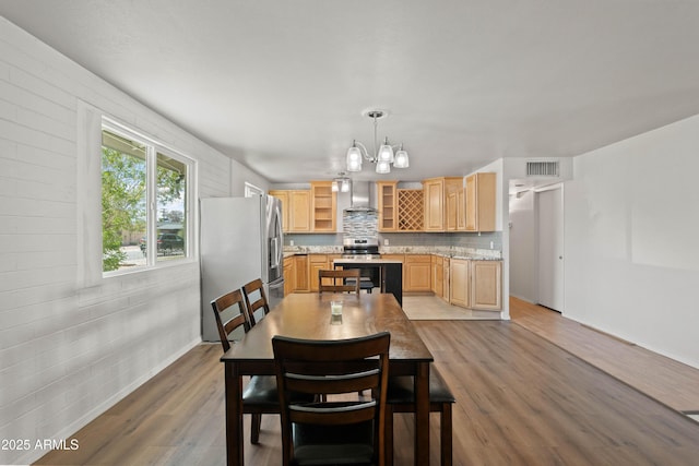 5802 N 61st Dr, Glendale, AZ 85301 - dining room featuring a chandelier, wood finished floors, and baseboards