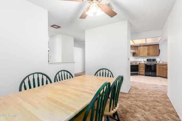 dining space with ceiling fan, a textured ceiling, visible vents, and light colored carpet