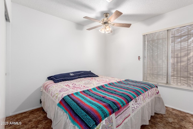 bedroom featuring carpet floors, a textured ceiling, baseboards, and a ceiling fan