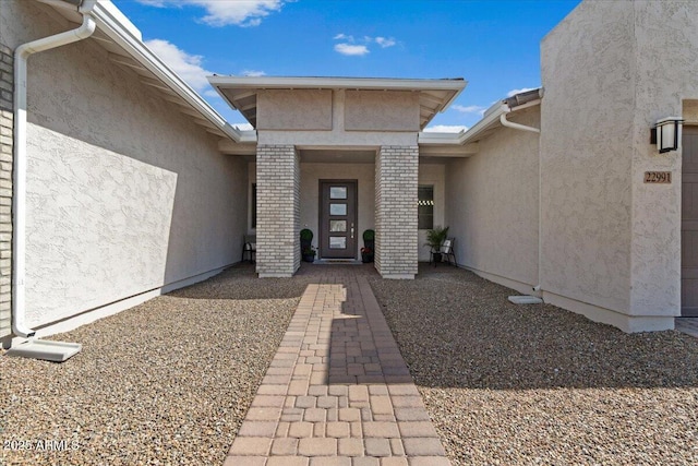 property entrance with stucco siding