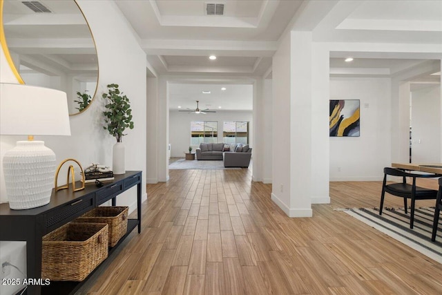 interior space featuring a ceiling fan, wood finished floors, and visible vents