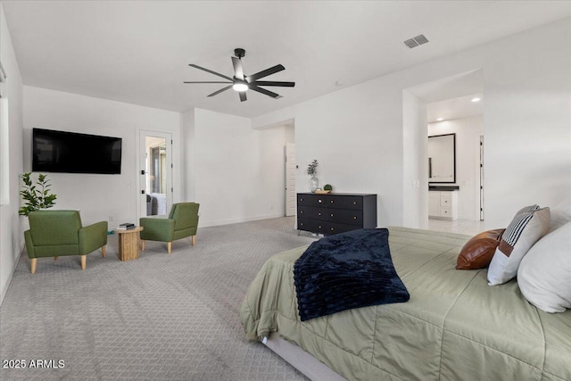 bedroom featuring a ceiling fan, visible vents, carpet floors, baseboards, and ensuite bathroom