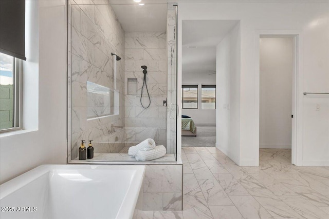 ensuite bathroom featuring plenty of natural light, marble finish floor, and a marble finish shower