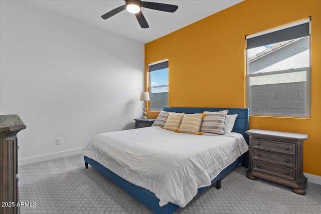 carpeted bedroom featuring baseboards and a ceiling fan