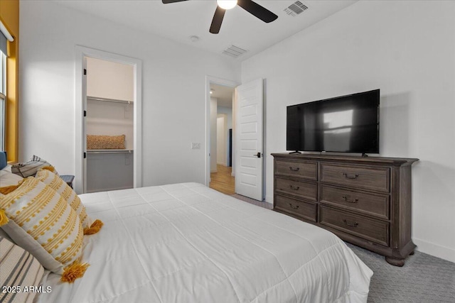 carpeted bedroom featuring visible vents, baseboards, and ceiling fan