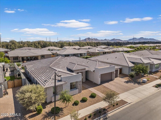 drone / aerial view featuring a residential view and a mountain view