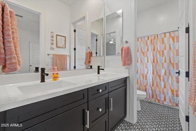 full bathroom with double vanity, toilet, visible vents, and a sink