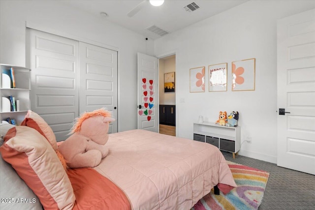 carpeted bedroom featuring a ceiling fan, visible vents, and a closet