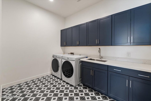 laundry room featuring cabinet space, baseboards, a sink, and washer and dryer