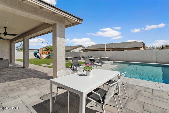 view of pool featuring a fenced backyard, outdoor dining area, a playground, and a patio area