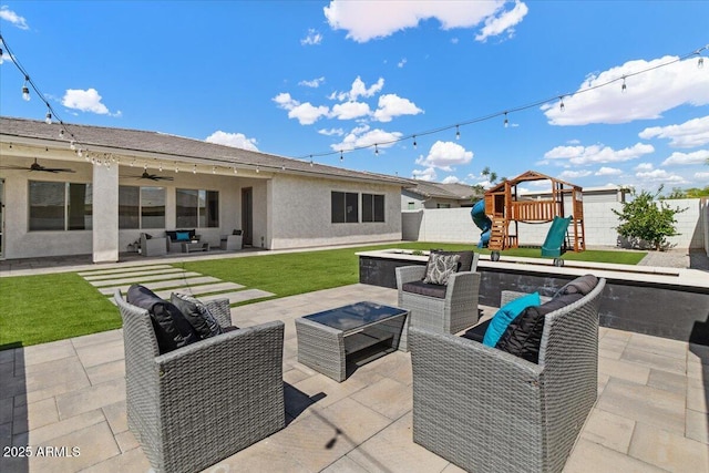 view of patio / terrace with an outdoor hangout area, a ceiling fan, a playground, and fence