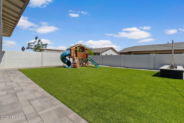 view of yard with a fenced backyard and a playground