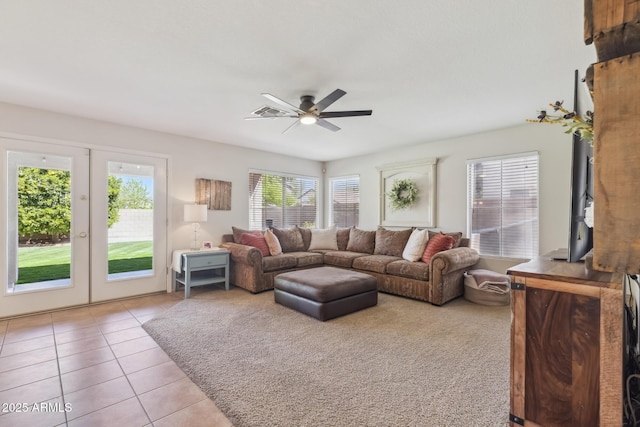 living area featuring light tile patterned floors, french doors, and a ceiling fan