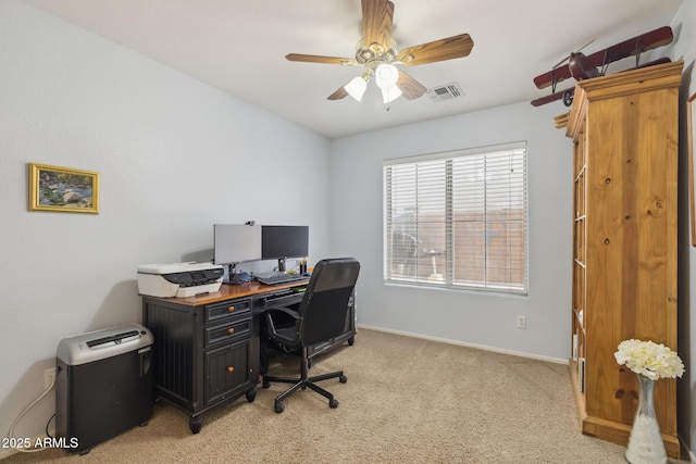 office area with light carpet, visible vents, a ceiling fan, and baseboards