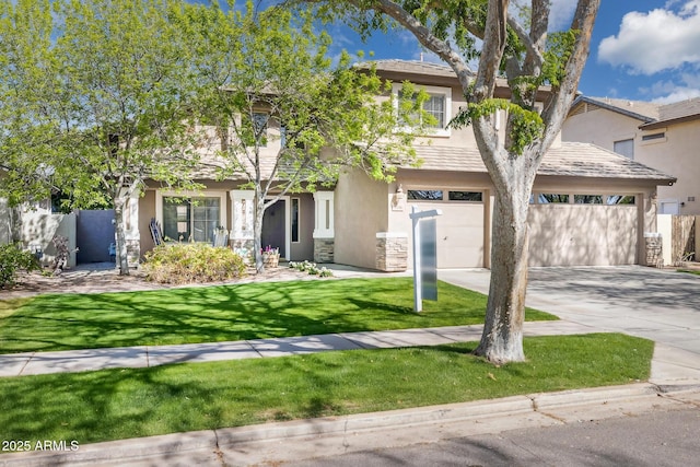 view of front of home featuring an attached garage, a front lawn, stucco siding, stone siding, and driveway