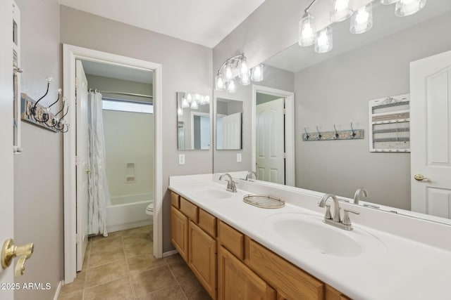 full bathroom with tile patterned floors, double vanity, shower / bath combo with shower curtain, and a sink