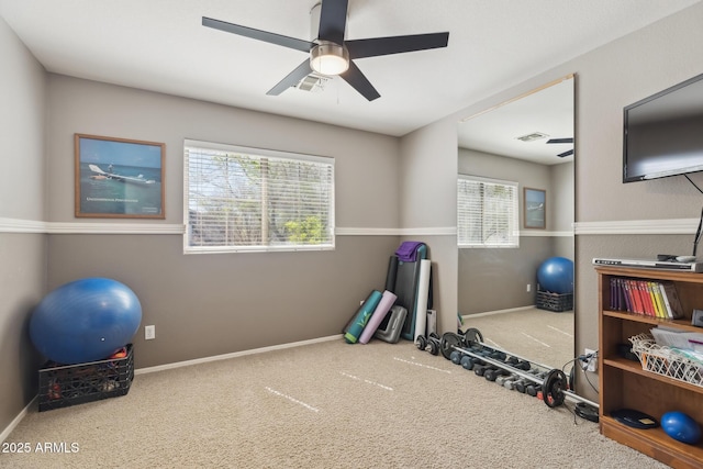 workout room with visible vents, baseboards, ceiling fan, and carpet flooring