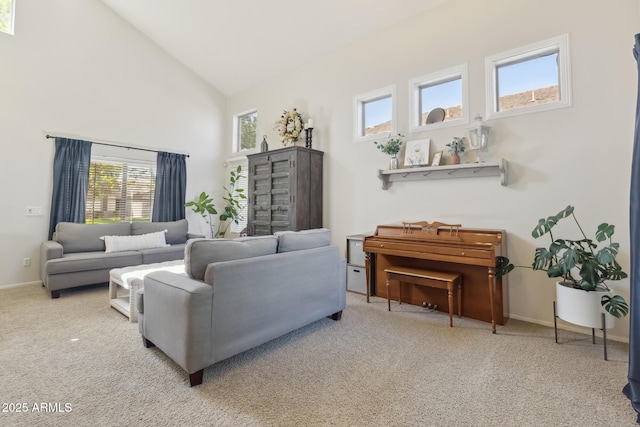 carpeted living room featuring high vaulted ceiling and baseboards