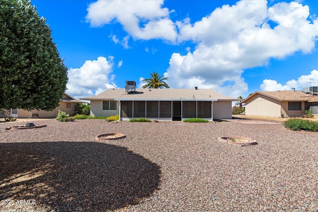 rear view of property with a sunroom