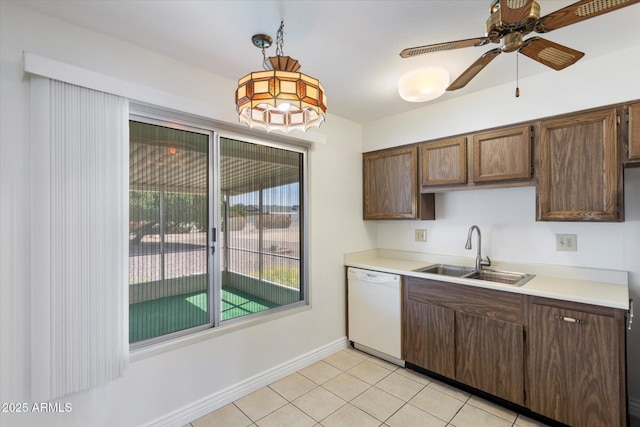 kitchen featuring ceiling fan, dishwasher, sink, hanging light fixtures, and light tile patterned floors