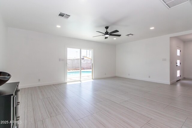 1011 W Weldon Ave, Phoenix, AZ 85013 - unfurnished living room featuring ceiling fan, baseboards, and recessed lighting