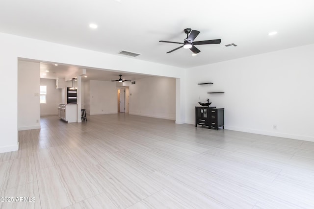 1011 W Weldon Ave, Phoenix, AZ 85013 - unfurnished living room featuring ceiling fan, baseboards, and recessed lighting