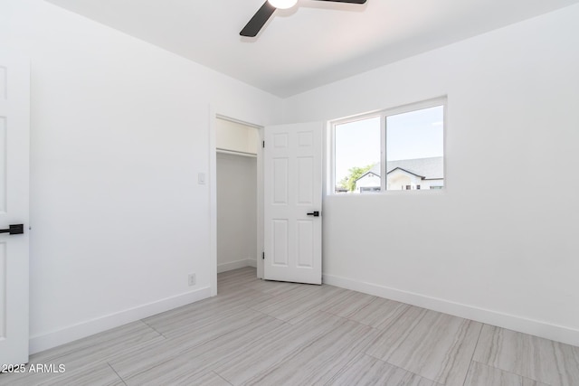 1011 W Weldon Ave, Phoenix, AZ 85013 - unfurnished bedroom with baseboards, a ceiling fan, a spacious closet, and a closet
