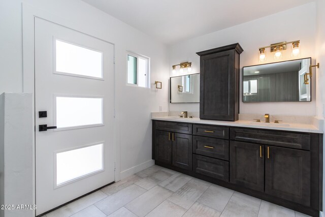 1011 W Weldon Ave, Phoenix, AZ 85013 - bathroom featuring baseboards and double vanity