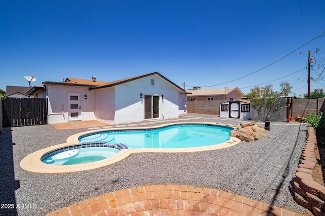 1011 W Weldon Ave, Phoenix, AZ 85013 - view of pool with a storage unit, a fenced backyard, a pool with connected hot tub, a patio, and an outbuilding