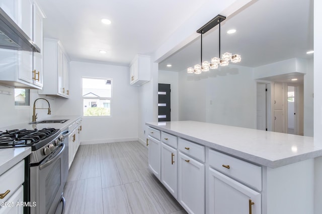 1011 W Weldon Ave, Phoenix, AZ 85013 - kitchen featuring a sink, wall chimney exhaust hood, white cabinets, stainless steel gas range, and recessed lighting