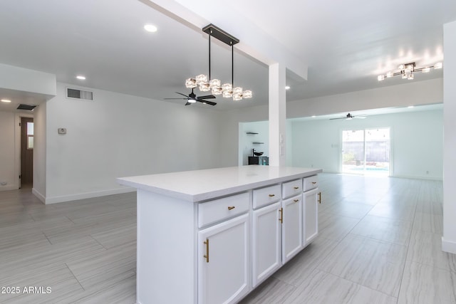 1011 W Weldon Ave, Phoenix, AZ 85013 - kitchen with open floor plan, a ceiling fan, light countertops, white cabinets, and recessed lighting