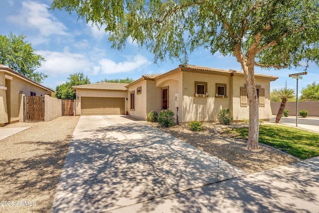 948 E Savannah Dr, Chandler, AZ 85225 - mediterranean / spanish-style home featuring stucco siding, driveway, a tile roof, a garage, and a gate