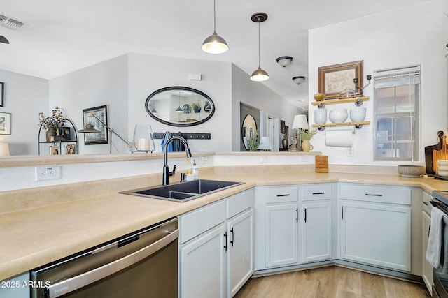 948 E Savannah Dr, Chandler, AZ 85225 - kitchen with stainless steel dishwasher, a sink, light wood-style floors, decorative light fixtures, and light countertops