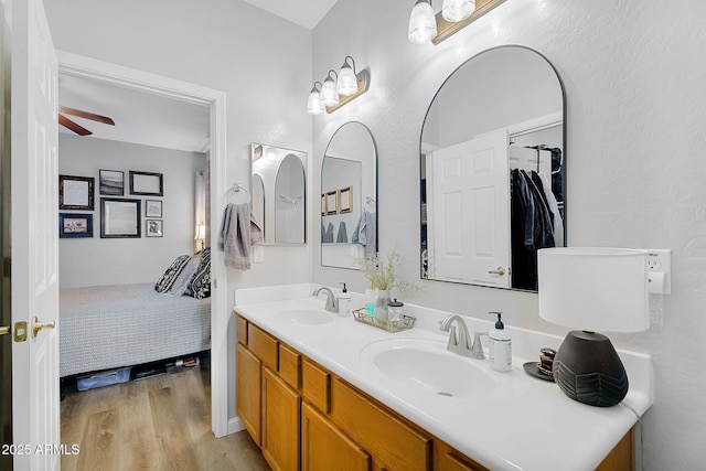 948 E Savannah Dr, Chandler, AZ 85225 - ensuite bathroom with double vanity, wood finished floors, and a ceiling fan