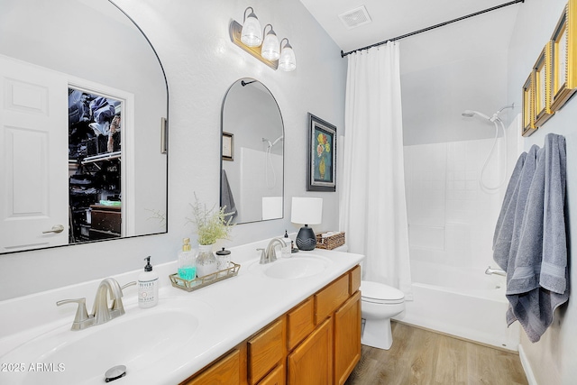 948 E Savannah Dr, Chandler, AZ 85225 - bathroom featuring shower / tub combo, toilet, double vanity, and wood finished floors