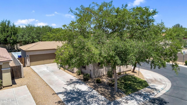 948 E Savannah Dr, Chandler, AZ 85225 - obstructed view of property featuring stucco siding, driveway, a garage, and a tile roof