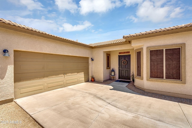 948 E Savannah Dr, Chandler, AZ 85225 - doorway to property with driveway, stucco siding, and a garage