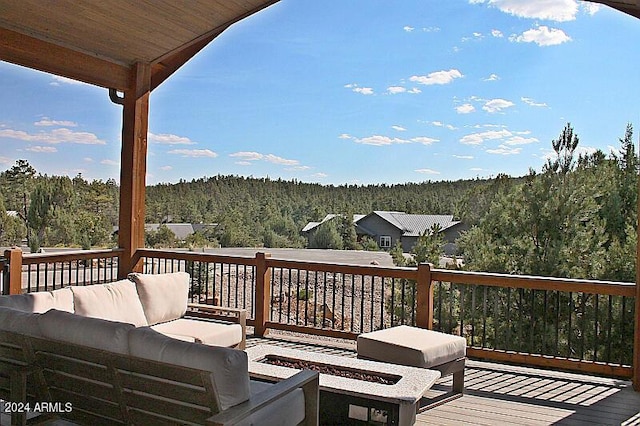 860 W Snow Creek Trl, Show Low, AZ 85901 - deck featuring a wooded view and an outdoor living space with a fire pit