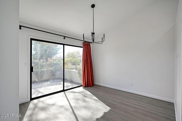 unfurnished dining area with hardwood / wood-style flooring and a notable chandelier