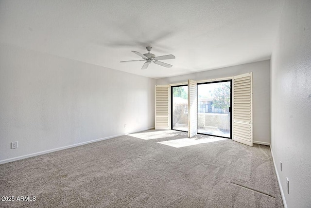 empty room with ceiling fan and light colored carpet