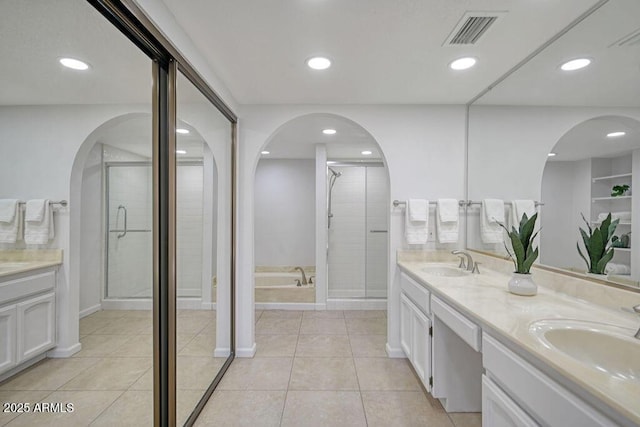 bathroom featuring tile patterned floors, vanity, and separate shower and tub