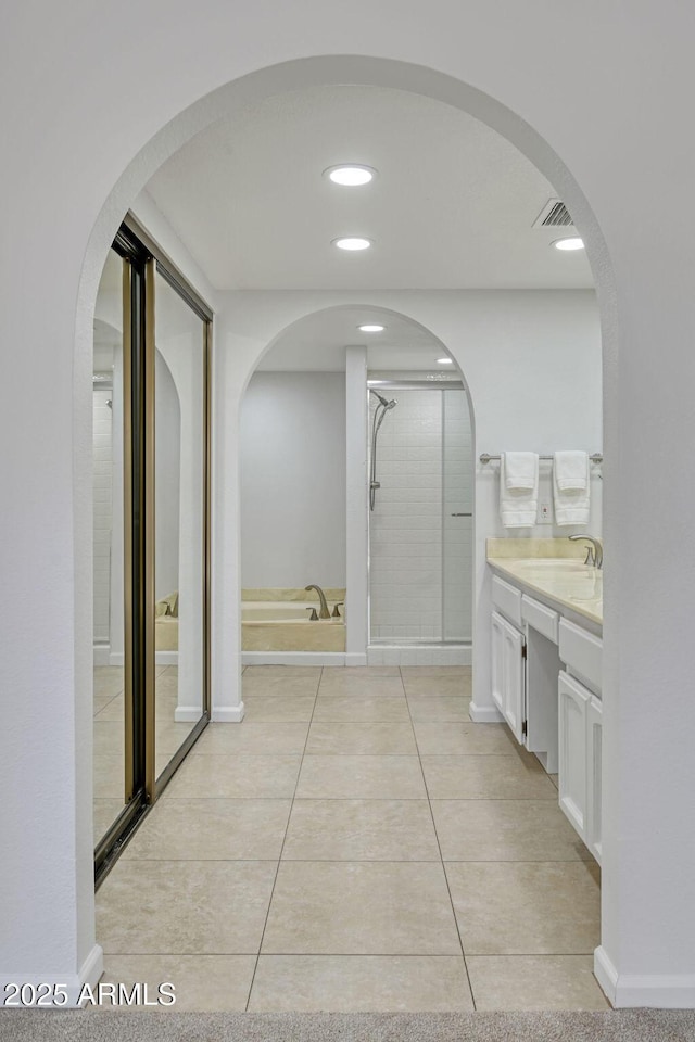 bathroom featuring vanity, an enclosed shower, and tile patterned floors