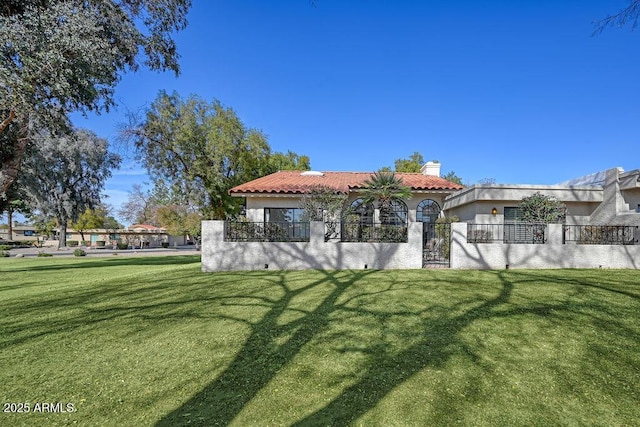 rear view of house featuring a lawn