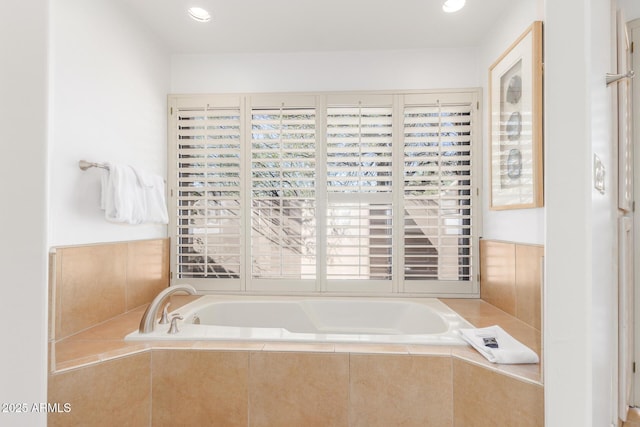 bathroom featuring a relaxing tiled tub